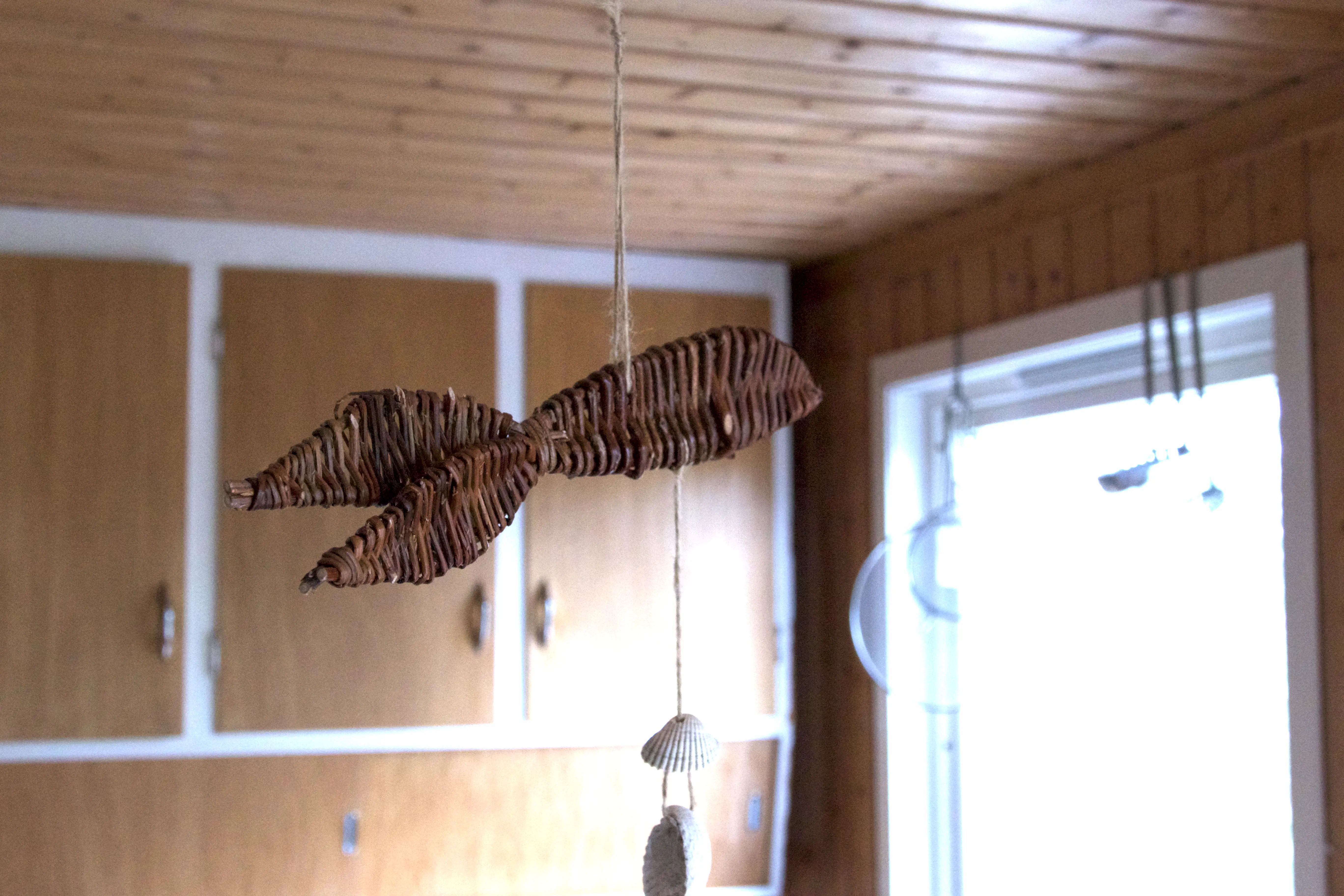 a decorative fish made ouf wood hanign from the celling