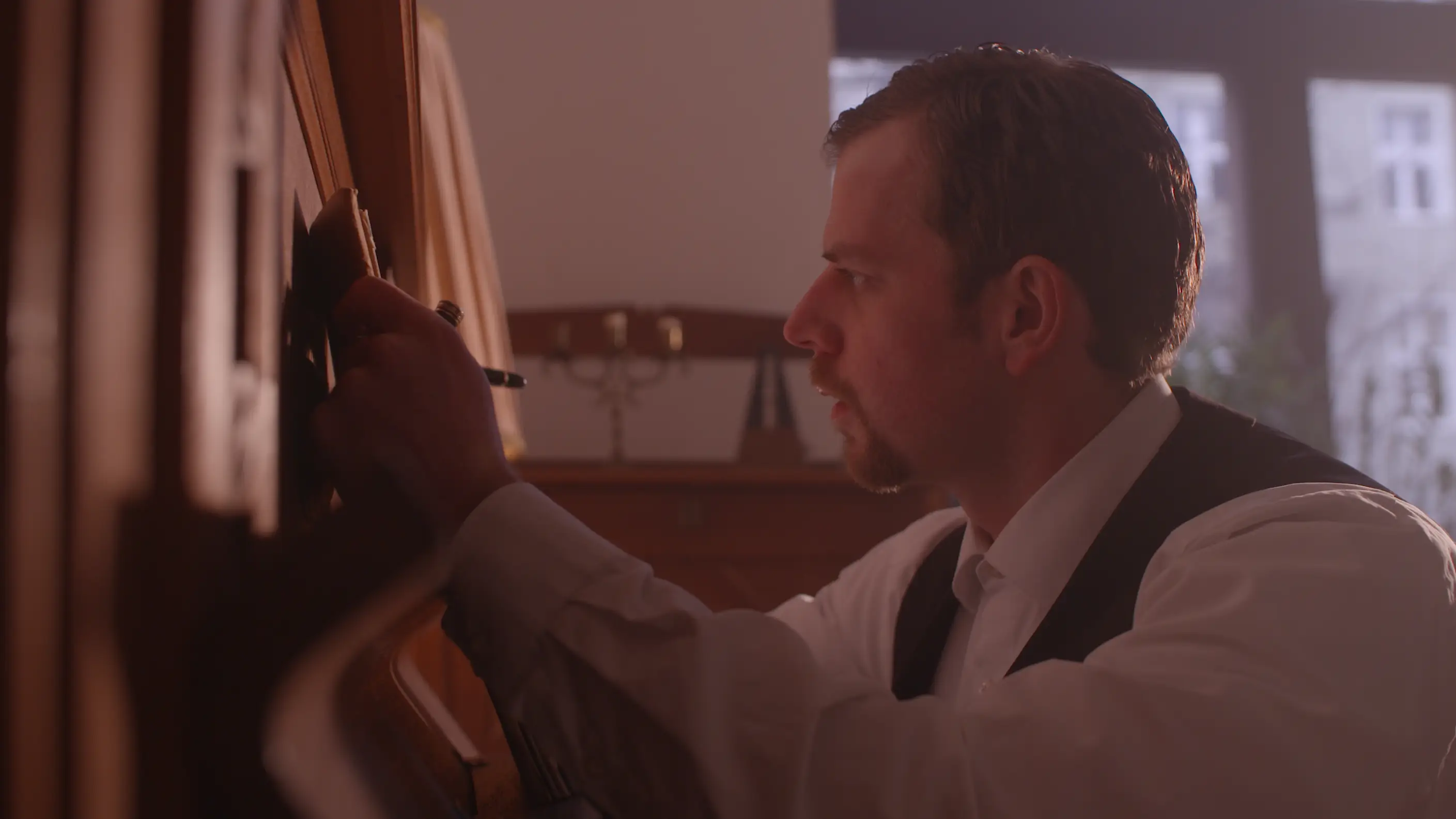 man writing something on paper